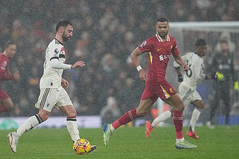 EPL 2024-25: Manchester United's Bruno Fernandes, left, controls a ball chased by Liverpool's Cody Gakpo