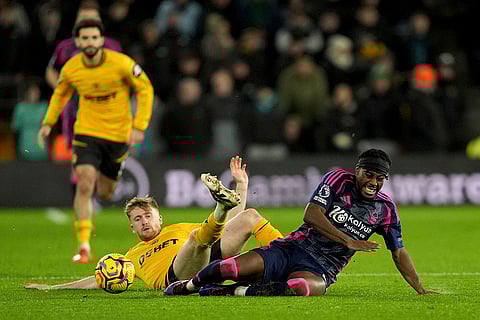 EPL 2024-25: Wolves Tommy Doyle, left, fouls Nottingham Forest's Anthony Elanga
