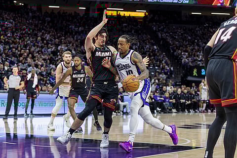 NBA 2024-25: Kings forward DeMar DeRozan, right, drives to the basket with Heat guard Jaime Jaquez Jr.