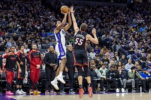 NBA 2024-25: Kings forward Keegan Murray, left, attempts a jump shot over Miami Heat forward