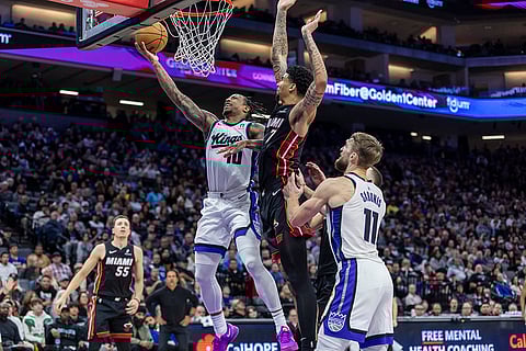NBA 2024-25: Kings forward DeMar DeRozan makes a layup past Heat center Kel'el Ware