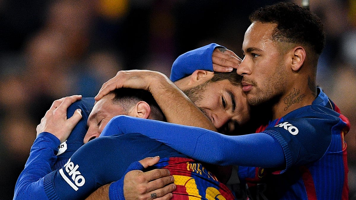 Neymar celebrates a goal alongside Lionel Messi and Luis Suarez in 2016
