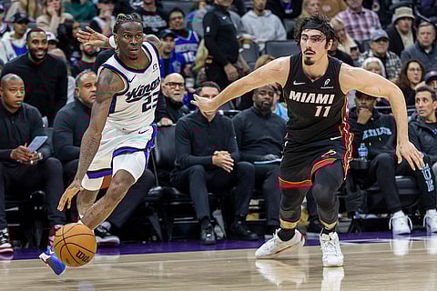 NBA 2024-25: Kings guard Keon Ellis, left, drives to the basket