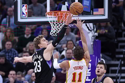 NBA 2024-25: Jazz forward Lauri Markkanen (23) blocks the shot of Hawks guard Trae Young
