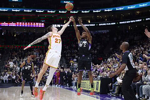 NBA 2024-25: Jazz guard Collin Sexton (2) shoots a three-point shot over Hawks guard Vit Krejci