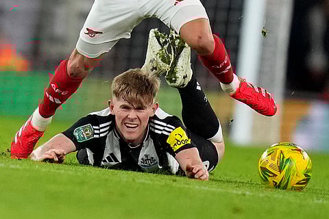 EFL Cup 2024-25: Newcastle's Lewis Hall falls as he fights for the ball with Arsenal's Leandro Trossard