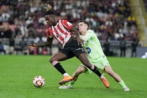 Spanish Super Semi-Final: Athletic Bilbao's Nico Williams, left, and Barcelona's Marc Casado fight for the ball
