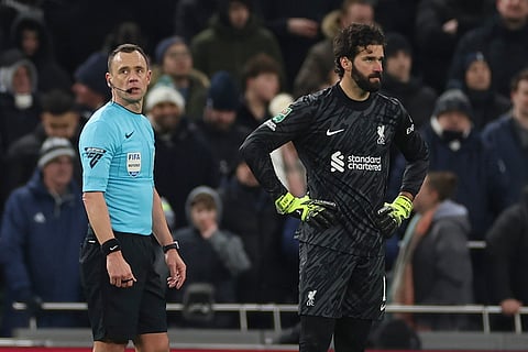 EFL Cup Semi-Final: Referee Stuart Attwell stands alongside Liverpool's Alisson