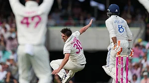 Photo: AP : Pat Cummins falls as he appeals unsuccessfully for a wicket during the second day of the fifth Test between India and Australia at the Sydney Cricket Ground.
