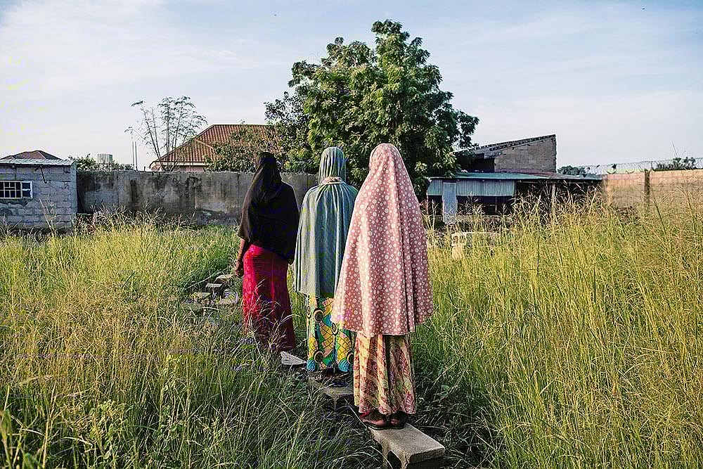 | Photo: Getty Images : Lonely Lives: Three young girls 
walk back home in Maiduguri, Nigeria