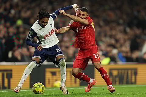 EFL Cup Semi-Final: Tottenham's Djed Spence duels for the ball with Liverpool's Mohamed Salah