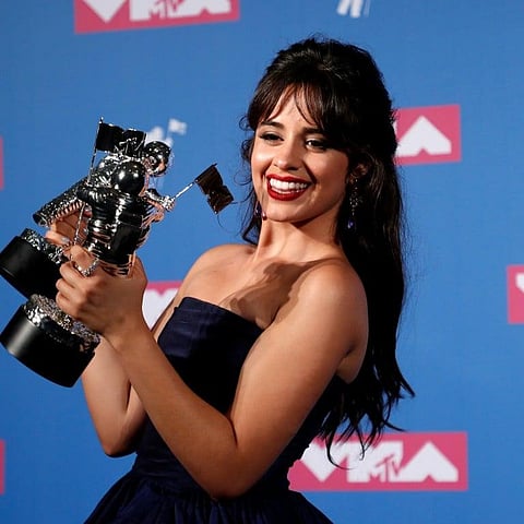 Camila Cabello posing with her awards