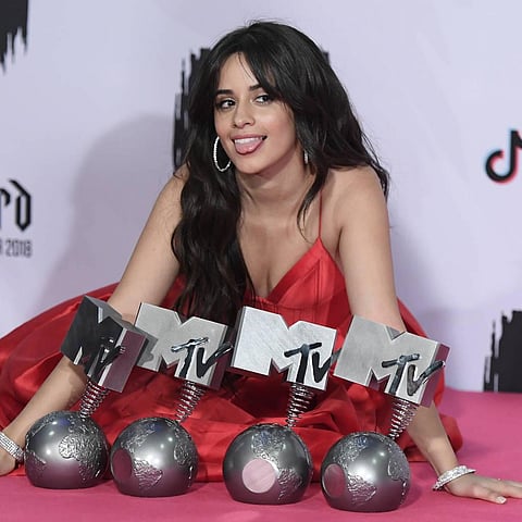 Camila Cabello posing with her awards