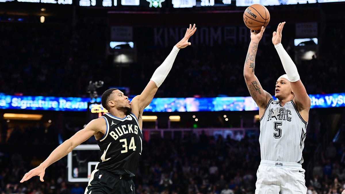 Paolo Banchero shoots a 3-pointer over Giannis Antetokounmpo