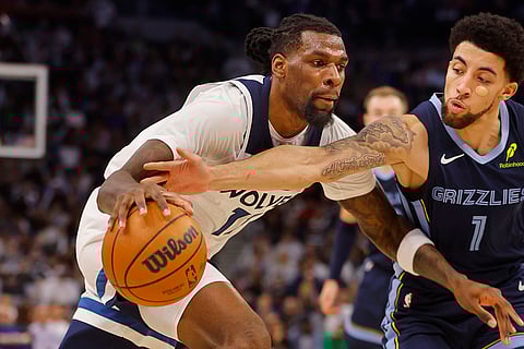 NBA 2024-25: Timberwolves center Naz Reid goes to the basket against Grizzlies guard Scotty Pippen Jr.
