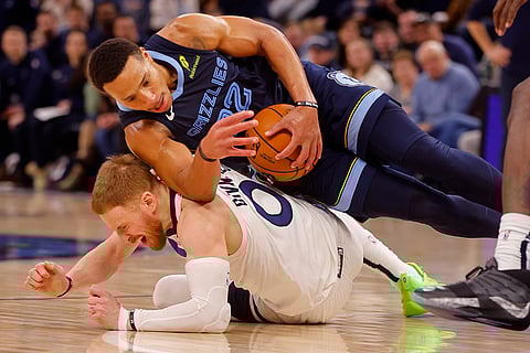 NBA 2024-25: Grizzlies guard Desmond Bane comes away with the ball atop Timberwolves guard Donte DiVincenzo