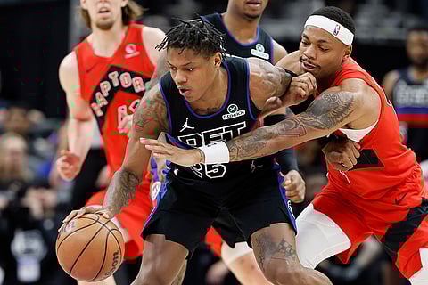 NBA 2024-25: Raptors forward Bruce Brown (11) tries to steal the ball from Pistons guard Marcus Sasser