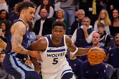 NBA 2024-25: Timberwolves guard Anthony Edwards (5) drives around Grizzlies center Brandon Clarke