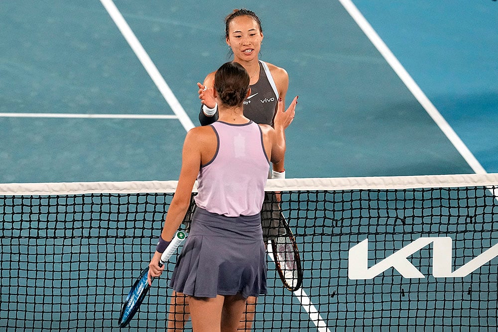 | Photo: AP/Manish Swarup : Australian Open 2025: Zheng Qinwen of China is congratulated by Anca Todoni of Romania
