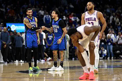 NBA 2024-25: Magic guard Trevelin Queen (12) and guard Cole Anthony (50) react after a score