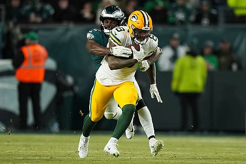 NFL Football Play-off - Packers vs Eagles: Packers running back Josh Jacobs (8) is tackled by Eagles linebacker Oren Burks