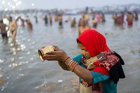 Kumbh Mela 2025: A devotee prays before taking a dip
