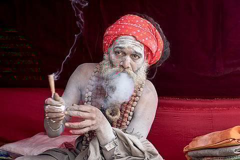Kumbh Mela 2025: A Hindu holy man smokes marijuana at his makeshift living quarters