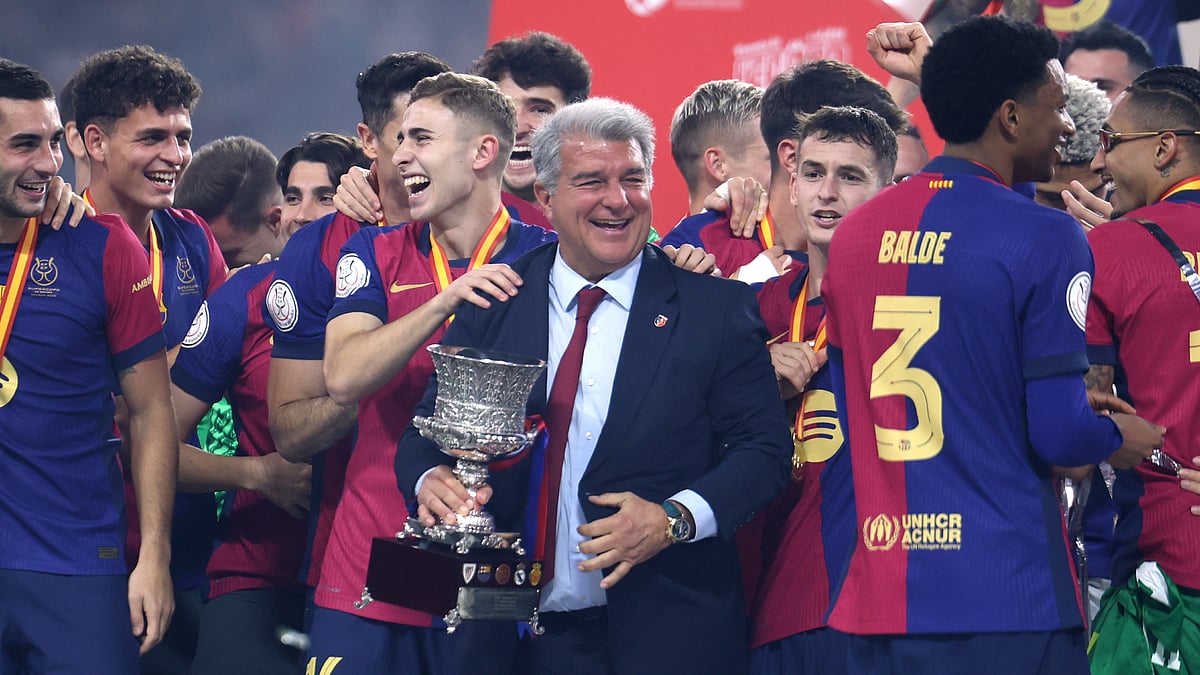 Joan Laporta with the Supercopa de Espana trophy after Barcelona's win over Real Madrid on Sunday