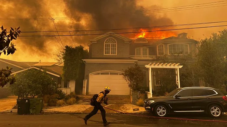 A firefighter in action at the Palisades Fire in Los Angeles - AP