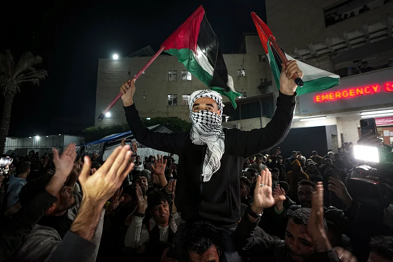 Palestinians celebrate the announcement of a ceasefire deal between Hamas and Israel