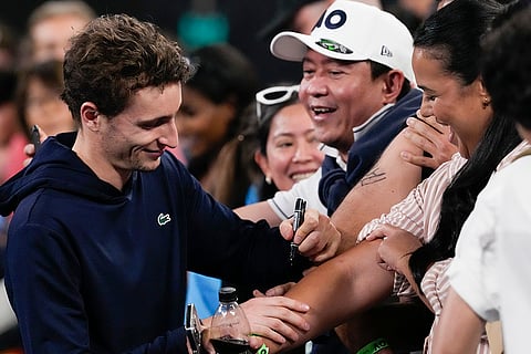 Australian Open 2025: Ugo Humbert of France signs his autograph following match against Arthur Fils