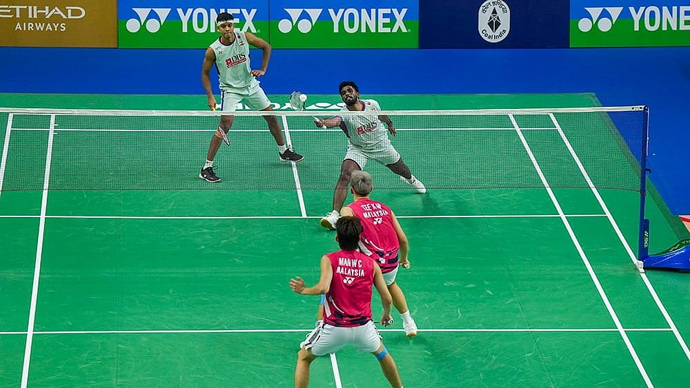 | Photo: PTI/Manvender Vashist Lav : BWF India Open 2025: India's Satwiksairaj Rankireddy and Chirag Shetty in action against Malaysia's Wei Chong Man and Tee Kai Wun