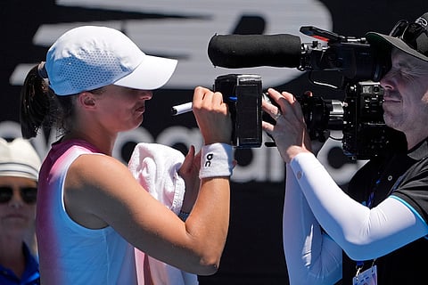 Australian Open 2025: Iga Swiatek signs a screen on a television camera