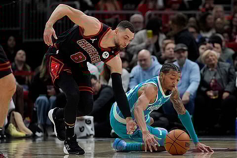 NBA 2024-25: Bulls guard Zach LaVine (8), left, grabs a loose ball from Hornets guard Nick Smith Jr.
