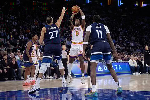 NBA 2024-25: Knicks' OG Anunoby (8) shoots over Timberwolves' Rudy Gobert (27) and Naz Reid