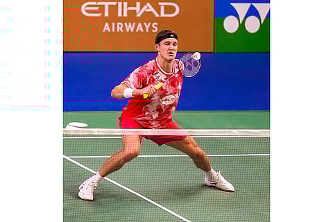 BWF India Open 2025: Denmark's Viktor Axelsen returns a shot against Singapore’s Loh Kean Yew