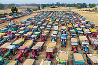 | Photo: PTI : The Agony of Waiting: Farmers line up their tractors with wheat grain at a wholesale market in Jabalpur