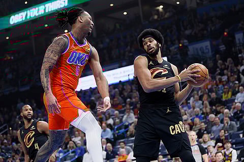 NBA 2024-25: Cavaliers center Jarrett Allen grabs a rebound next to Thunder forward Jaylin Williams