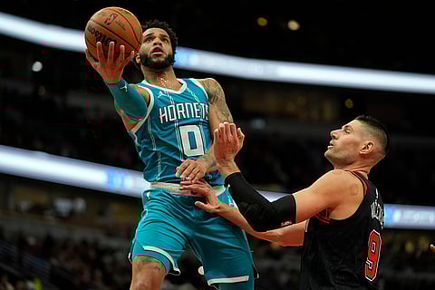 NBA 2024-25: Bulls center Nikola Vucevic (9) guards against Hornets forward Miles Bridges