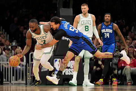 NBA 2024-25: Celtics' Jaylen Brown (7) steals the ball from Magic's Cole Anthony
