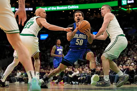 NBA 2024-25: Magic's Cole Anthony (50) is defended by Celtics' Jordan Walsh