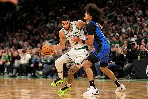 NBA 2024-25: Celtics' Jayson Tatum, left, is fouled by Orlando Magic's Anthony Black