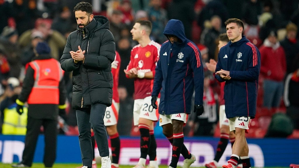 Manchester United's head coach Ruben Amorim, left, walks on the pitch at the end of the English Premier League match against Brighton and Hove Albion at the Old Trafford stadium. - AP