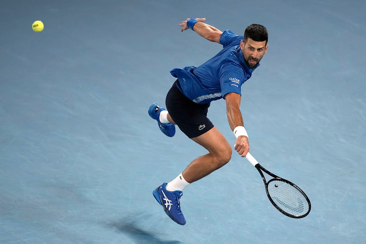 (AP Photo/Ng Han Guan) : Novak Djokovic of Serbia plays a backhand return