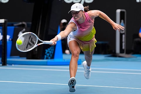 Australian Open Tennis quarterfinal: Iga Swiatek plays a backhand return to Emma Navarro