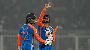 AP Photo/Bikas Das : India's Abhishek Sharma, right, celebrates after scoring fifty runs during the first T20 cricket match between India and England at Eden Gardens in Kolkata.