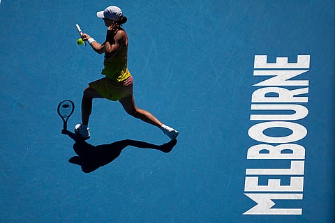 Australian Open Tennis quarterfinal: Iga Swiatek plays a forehand return to Emma Navarro