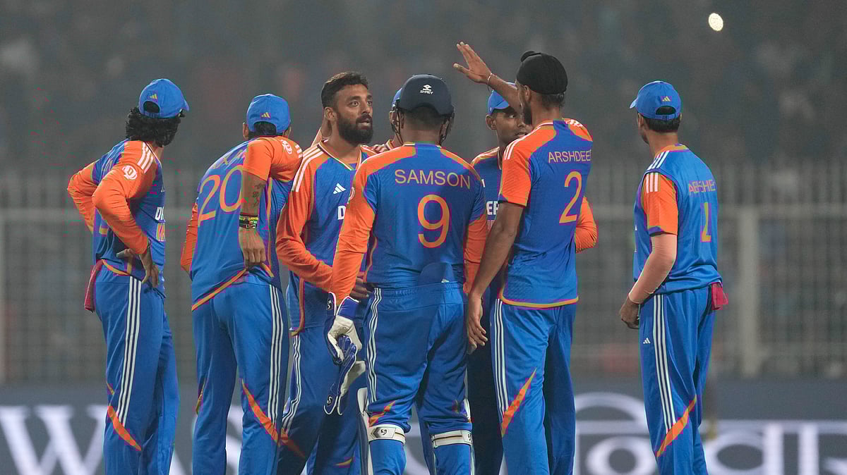 Indias Varun Chakravarthy, third left, celebrates with teammates. AP Photo