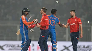 AP Photo/Bikas Das : England's captain Jos Buttler, second left, congratulates India's Tilak Varma after India won the first T20 cricket match against England at Eden Gardens in Kolkata.
