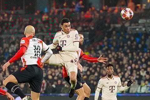 Champions League 2024-25: Bayern's Jamal Musiala jumps for the ball with Feyenoord's Gernot Trauner